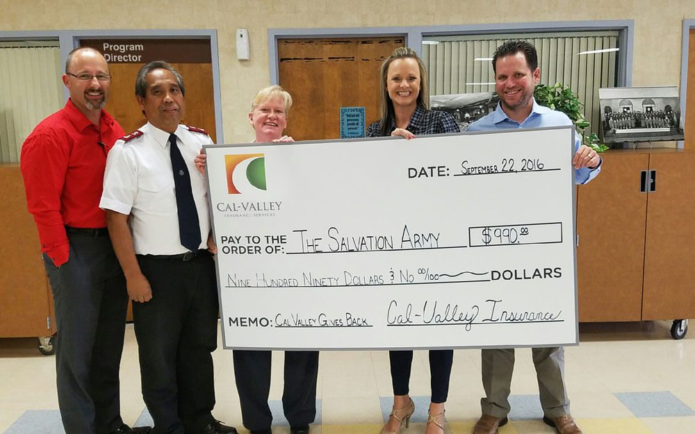 Brian, Kelly & Clint presenting a check to The Salvation Army